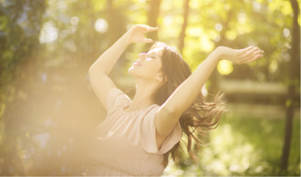 a women enjoying a sunshine in nature