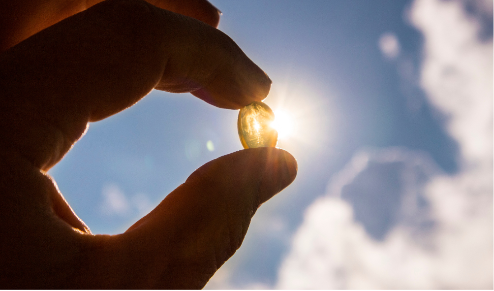 a person holding Vitamin tablet in sunshine